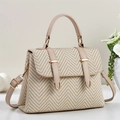 Detailed view of the woven herringbone texture and premium faux leather straps on the handbag - Apricot