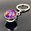 Detailed view of the double-sided glass orb keychain showing purple galaxy nebula patterns - Orange Purple Nebula Style (XSWX2275-10)
