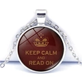 Macro shot of silver pendant featuring Keep Calm and Read On text and crown symbol - Red Crown Read On Style (JY008111-11)