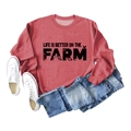 Detail of brick red farm-themed sweatshirt with tractor and chicken print on chest - Red Sweatshirt (Black Text Pattern)