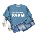 Flat lay of blue cotton sweatshirt with Life Is Better On The Farm farm-themed graphic - Blue Sweatshirt (White Text Pattern)