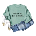 Flat lay of a light green crewneck sweatshirt with First of all text and blue denim jeans - S / Light Green Sweatshirt (Black Font)