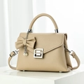 Detail of beige litchi grain leather bag with bow, pearl pendant and silver G-buckle - Khaki