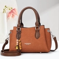 Brown woven tote bag for women with leather handles and decorative wooden bead charm - Caramel color