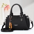 Classic black leather tote bag with elegant wood bead charm and adjustable strap for women - Black