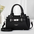 Detail of black leather handbag with silver twist lock closure and fine hardware texture - Black