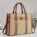 Detail of the chic beige and brown leather tote bag with stylish striped ribbon accents - Khaki