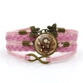 Bracciale steampunk teschio in pelle rosa con ciondoli a farfalla e infinito in bronzo - Rosa