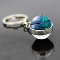 Macro detail of aurora borealis glass ball keychain with silver metal base and reflection - Jy008212-8