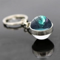 Macro shot of double-sided glass ball keychain with aurora borealis and forest scenery - Coniferous Forest Snow Aurora Style (JY008212-7)