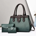 Detailed view of the dark green tote bag set with pebble leather texture and silver hardware - Three-Piece Set / Green