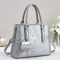 Silver metallic textured handbag with vertical stripes and a small matching bag charm - Gray