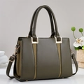Detailed shot of olive green handbag with gold hardware and woven texture accents - Green