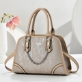 Detail of beige textured handbag with vertical stripes and silver chain accessory - Khaki