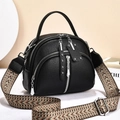 Elegant black lychee texture crossbody bag with silver zippers and wide woven strap - Black