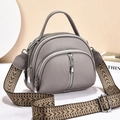 Gray pebble leather crossbody bag with multiple zippers and geometric patterned strap - Gray