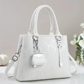 Detail of white tote bag with vertical stripes, silver hardware, and mini charm - Off White