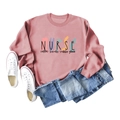 Flat lay of pink Nurse Coffee Scrubs sweatshirt with jeans and white canvas shoes - Rose Gold (Black Letters)