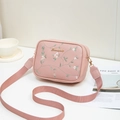 Pink embroidered camera crossbody bag with floral patterns and woven strap detail - Pink
