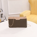 Vintage brown crossbody bag with geometric print and gold chain strap on table - Apricot