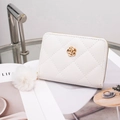 White quilted faux leather wallet with golden flower logo and white fluffy pom pom charm - White