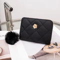 Quilted black short wallet with golden camellia floral buckle and plush ball charm - Black