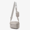 Light grey nylon crossbody camera bag with adjustable strap and small detachable pouch - Gray
