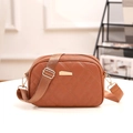Brown quilted crossbody bag with adjustable wide strap and gold metal hardware detail - Brown