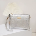 Silver stone texture crossbody clutch with gold hardware on a minimalist white display - Silver