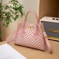 Pink printed leather trapezoid handbag with gold twist lock and adjustable strap - Pink