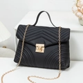 Chic black wave-quilted mini flap bag with gold chain strap and metallic twist lock - Black