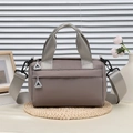 Borsa a mano cilindrica color tortora in tela con manici larghi e tracolla regolabile - Grigio