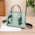 Mint green quilted handbag with decorative silk scarf handle and wide lettered strap - Green