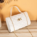 White quilted crossbody bag with gold chain strap and metal lock on wooden surface - White