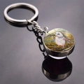 Macro view of hedgehog glass keychain reflecting on a dark glossy surface with sharp details - Holding White Flower Style (JY008498-11)