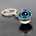 Macro shot of glass ball keychain showing the intricate blue evil eye mandala pattern - Jy008522-8
