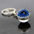 Macro detail of silver keychain with double-sided glass orb featuring teal evil eye pattern - Blue Green Radial Floral Style (JY008522-7)