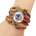 Macro shot of multi-layer woven leather bracelet featuring Statue of Liberty and USA flag charm - USA New York City Motif (JY008529-10)