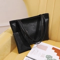 Chic black tote bag set with crocodile texture and matching pouch on a yellow sofa - Black