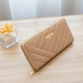 Women's long quilted wallet in light khaki with gold zipper on wooden background - Apricot