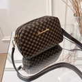 Brown crossbody bag with gold floral patterns and adjustable leather strap on reflective glass - Rhombus Coffee