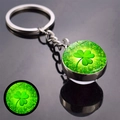 Macro detail of glowing four-leaf clover pendant on a silver keychain with mirror reflection - Luminous Four-Leaf Clover Radiating Style (JY008582-5)
