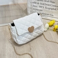Close-up of white quilted mini bag with golden heart buckle and fine chain strap - White