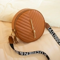 Brown round V-quilted crossbody bag with metallic tassel and woven letter strap - Brown