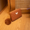 Caramel quilted short wallet for women featuring butterfly hardware and faux fur pom pom - Brown