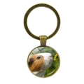 Detailed close-up of a vintage bronze guinea pig keychain with a glass cabochon pendant - White & Brown Guinea Pig Sniffing Flowers (JY008596-Copper 7)