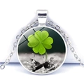 Macro view of a silver four-leaf clover crystal glass pendant necklace with a green motif - Silver Base Four Leaf Clover Fresh Light Background (Silver 3)