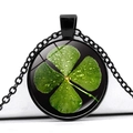 Close-up of green four-leaf clover crystal glass pendant necklace with black metal frame - Black Base Dew Drop Four Leaf Clover Black Background (Black 6)