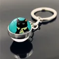 Close-up of a glass dome keychain with an anthropomorphic black cat in a green shirt - Funny Tie Black Cat(XSWX2233-12)