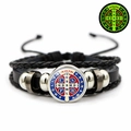 Macro detail of St. Benedict medal on black leather woven religious bracelet - Red Blue Color Cross Style (JY008668-7)